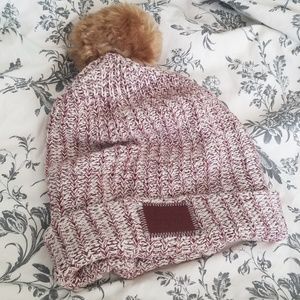 Burgundy speckled Love Your Melon pom beanie